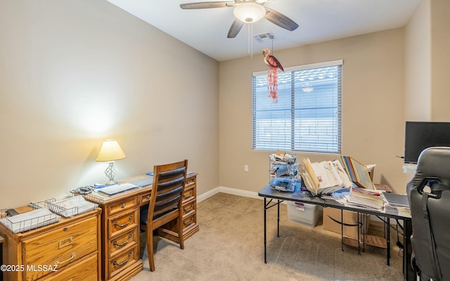 home office featuring light colored carpet, ceiling fan, visible vents, and baseboards