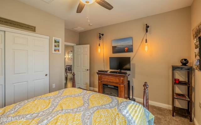 bedroom featuring a ceiling fan, carpet, a closet, and baseboards