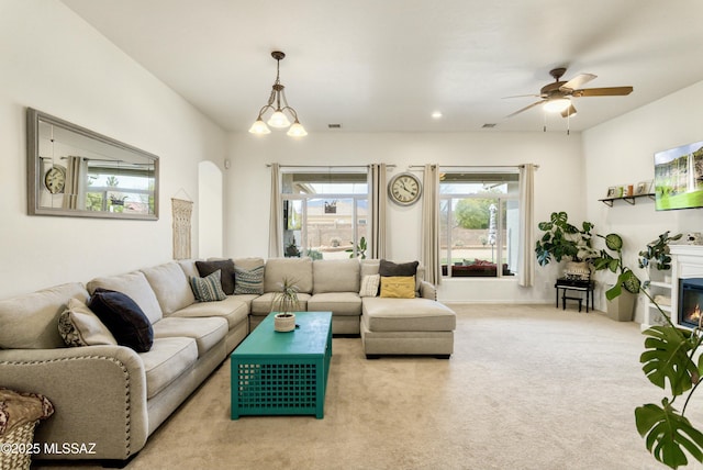 living area with ceiling fan, recessed lighting, carpet floors, visible vents, and a glass covered fireplace