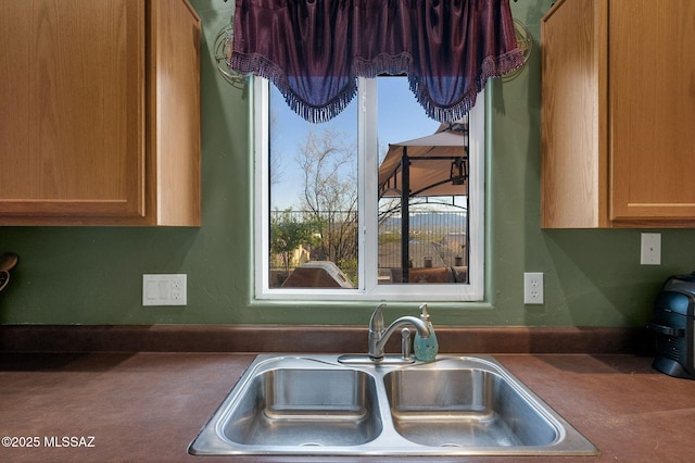 kitchen with dark countertops and a sink