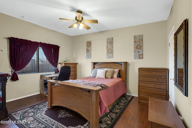 bedroom with hardwood / wood-style floors, visible vents, a ceiling fan, and baseboards