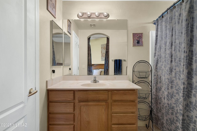 bathroom with a shower with shower curtain, visible vents, vanity, and tile patterned flooring