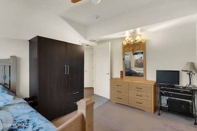 bedroom featuring visible vents, light carpet, and ceiling fan with notable chandelier