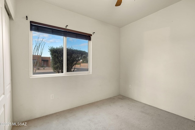 unfurnished room with carpet flooring and a ceiling fan