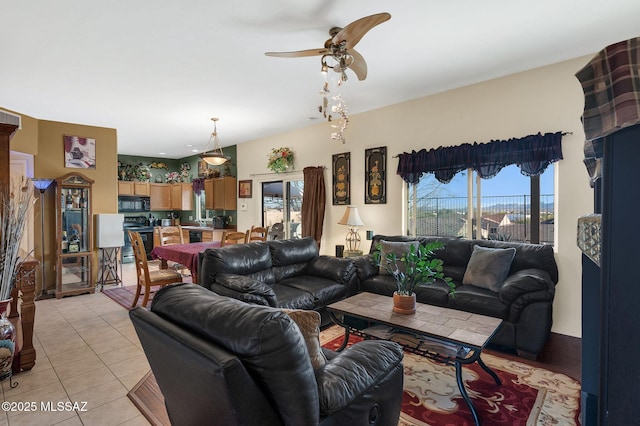 living room with light tile patterned floors, a healthy amount of sunlight, and a ceiling fan