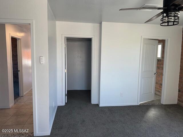 unfurnished bedroom with ceiling fan and carpet flooring