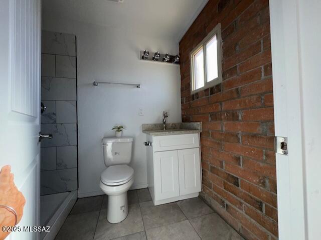 full bath featuring a shower, tile patterned flooring, vanity, and toilet