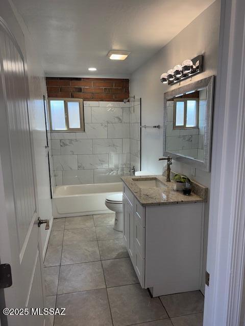 full bathroom featuring toilet, vanity, tile patterned flooring, and a wealth of natural light