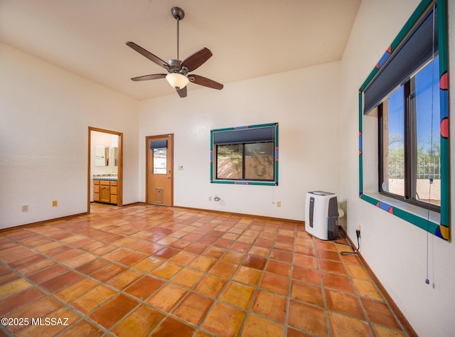 unfurnished room with tile patterned floors, baseboards, and a ceiling fan