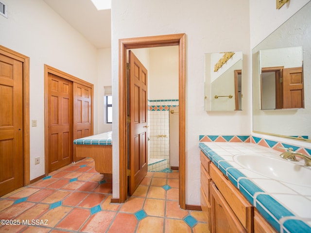 bathroom featuring tile patterned floors, visible vents, and vanity