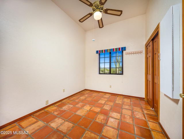 spare room with tile patterned flooring, baseboards, and ceiling fan