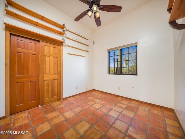 interior space featuring baseboards, ceiling fan, and tile patterned flooring