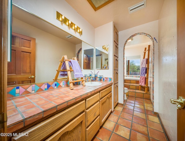 bathroom with tile patterned floors, visible vents, toilet, and vanity