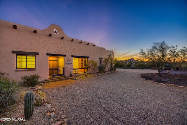 view of back of property at dusk