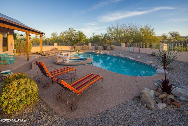 view of pool with a patio area, a fenced backyard, and a pool with connected hot tub