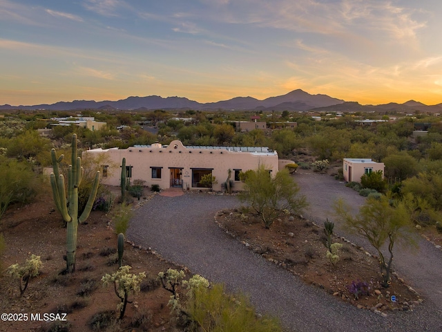 pueblo revival-style home featuring a mountain view and stucco siding