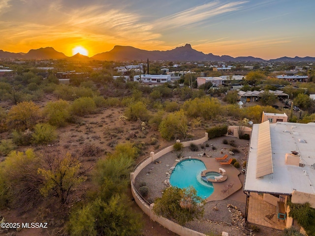 aerial view at dusk featuring a mountain view