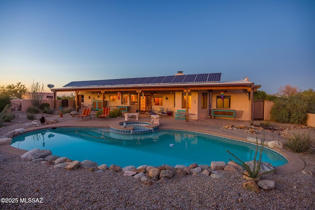 view of swimming pool with a patio, a fenced backyard, and a pool with connected hot tub