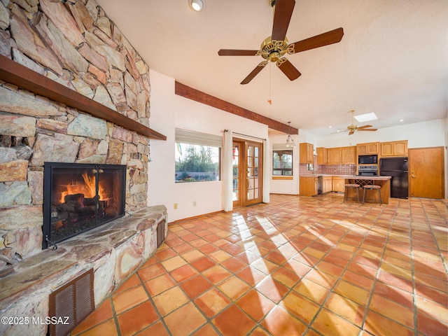 unfurnished living room with a stone fireplace, light tile patterned floors, french doors, and visible vents