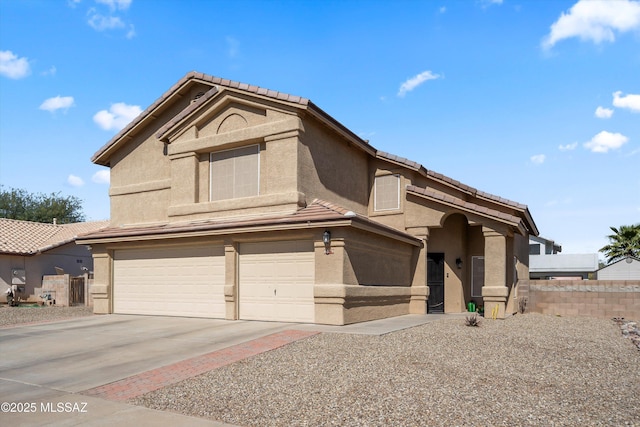 view of front facade featuring a tiled roof, stucco siding, an attached garage, and concrete driveway