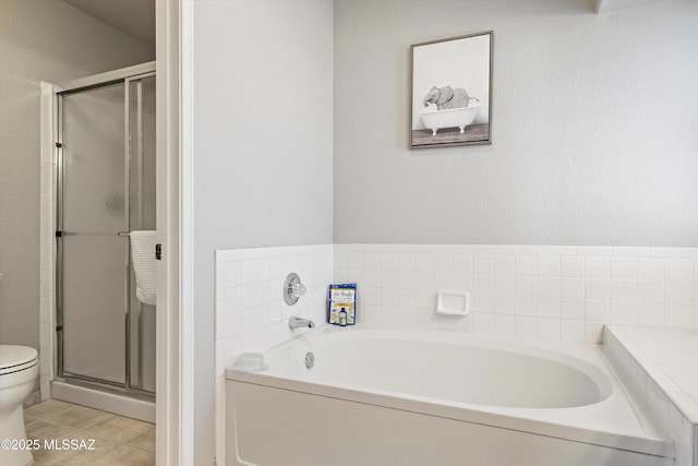 full bath with tile patterned floors, a garden tub, toilet, and a shower stall