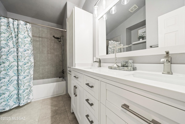 full bath featuring a sink, visible vents, double vanity, and tile patterned flooring