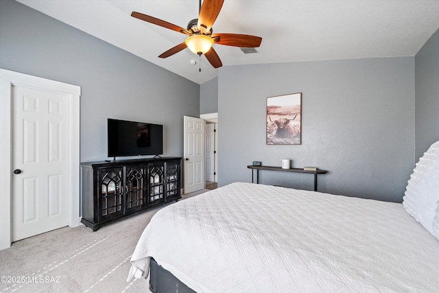 bedroom with lofted ceiling, a ceiling fan, visible vents, and carpet floors