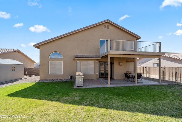 back of property with stucco siding, a patio, a lawn, and a fenced backyard