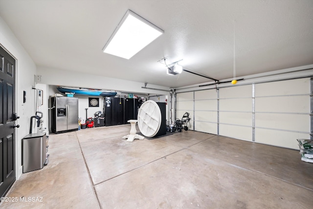 garage featuring a garage door opener and stainless steel refrigerator with ice dispenser