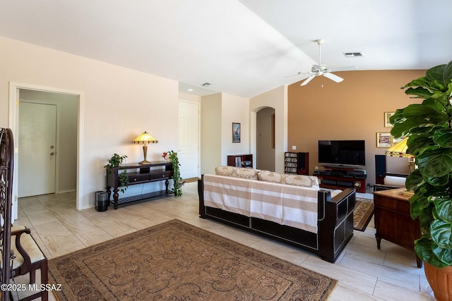 living room with lofted ceiling, visible vents, arched walkways, and ceiling fan