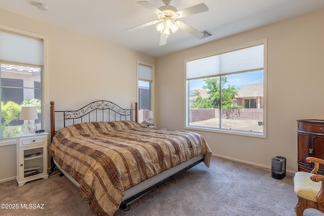 bedroom featuring ceiling fan, carpet floors, visible vents, and baseboards