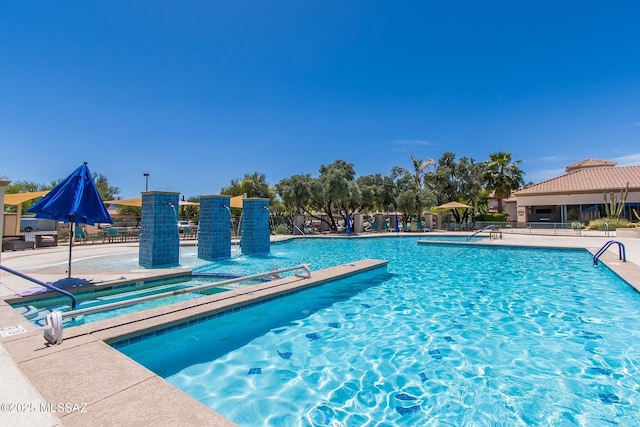 pool featuring fence, a patio, and a jacuzzi