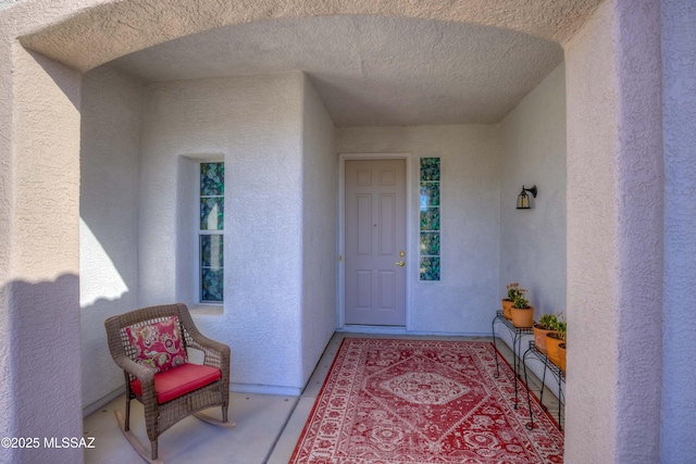 property entrance with stucco siding