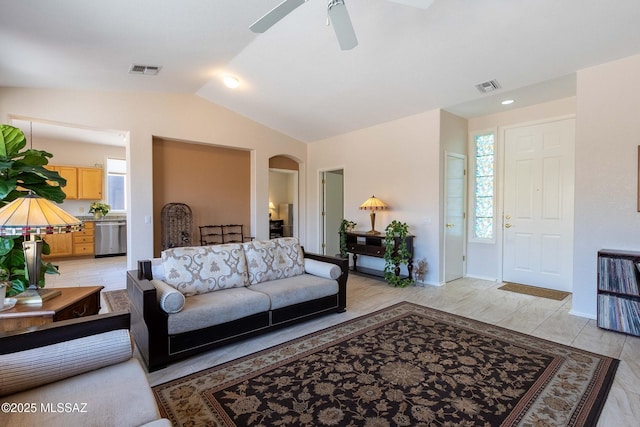 living area with vaulted ceiling, visible vents, arched walkways, and a wealth of natural light