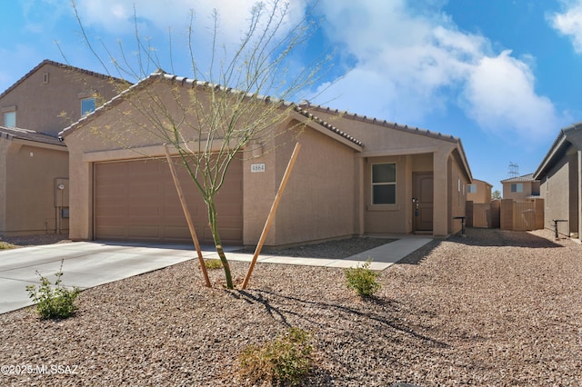 view of property exterior featuring a garage, a tiled roof, concrete driveway, and stucco siding