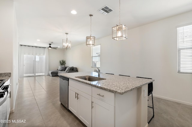 kitchen with stainless steel appliances, a wealth of natural light, a sink, and visible vents