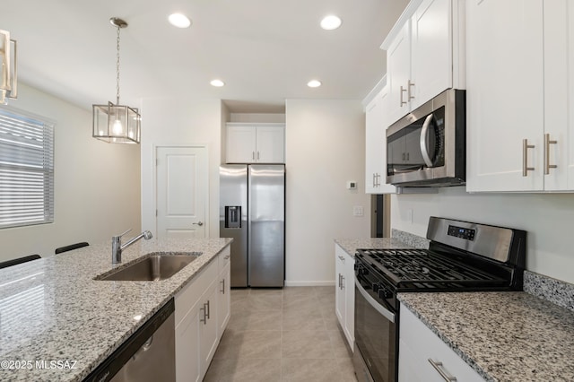 kitchen with appliances with stainless steel finishes, recessed lighting, white cabinetry, and a sink