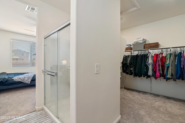 walk in closet with carpet floors and visible vents