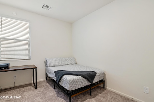 bedroom with carpet, visible vents, and baseboards