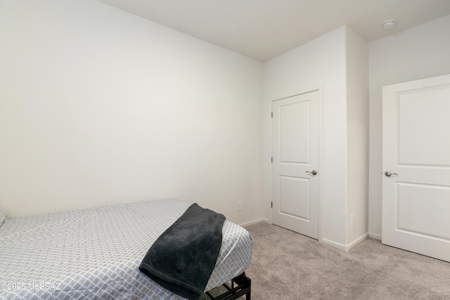 carpeted bedroom with baseboards