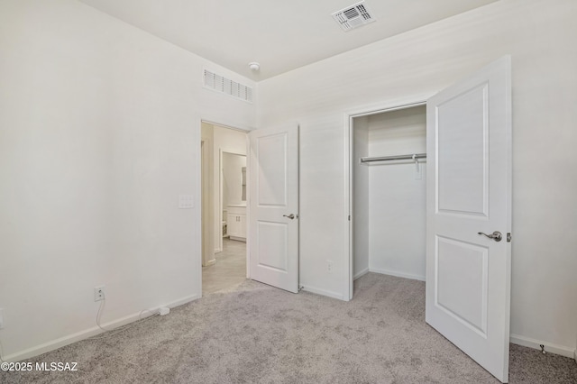 unfurnished bedroom with carpet floors, a closet, visible vents, and baseboards