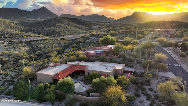 aerial view at dusk featuring a mountain view