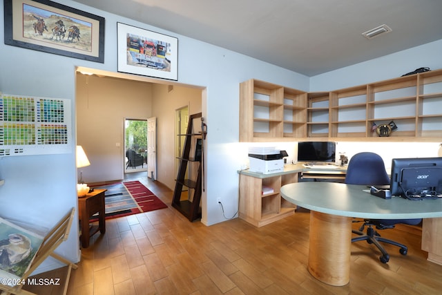 office area with visible vents and wood finished floors