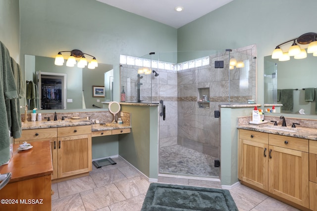 bathroom with two vanities, a sink, and a shower stall