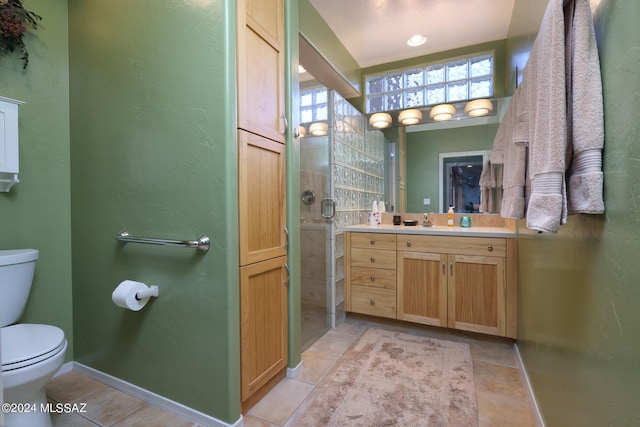 full bathroom featuring a textured wall, tile patterned flooring, toilet, vanity, and baseboards