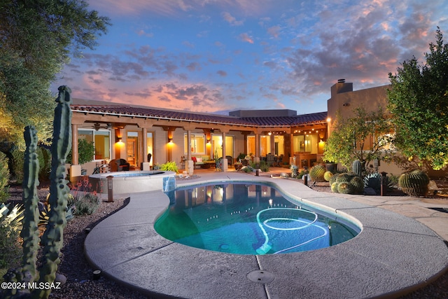 view of pool with a pool with connected hot tub, a ceiling fan, and a patio