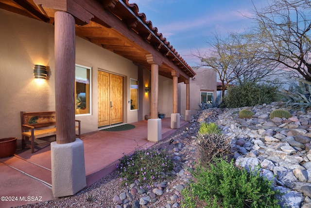 exterior entry at dusk with stucco siding