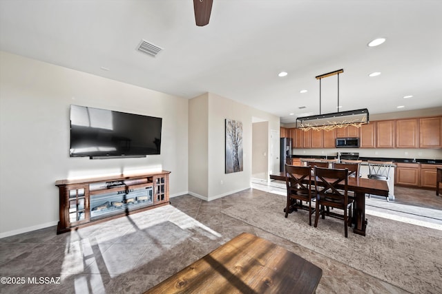 living room with recessed lighting, baseboards, and visible vents