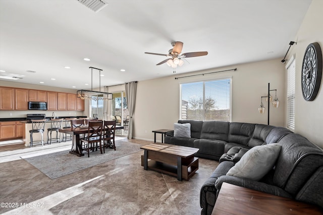 living area featuring a wealth of natural light, visible vents, and recessed lighting