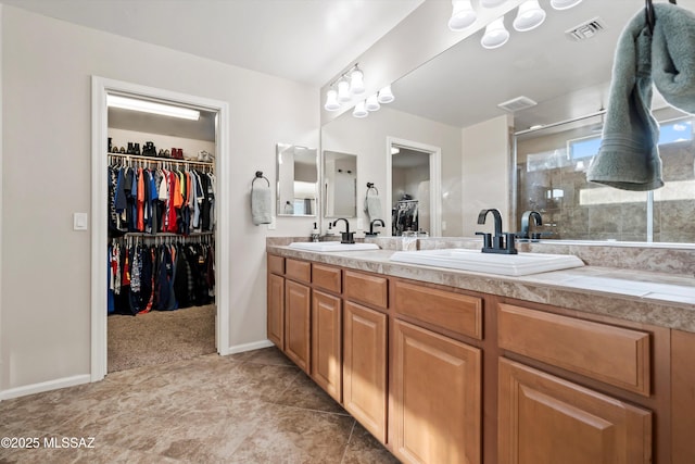 bathroom with a sink, visible vents, and a stall shower